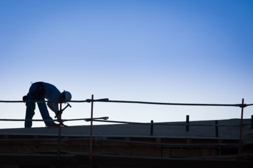 man working on commercial roofing repairs